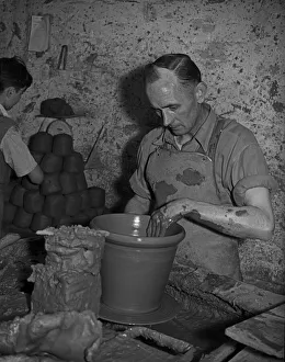 01186 Prints: Bilston Pottery 5th May 1958 A potter seen here throwing a large flower pot