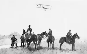 Biplane flying over British Patrol circa September 1914