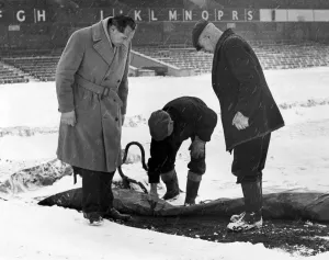00469 Prints: Birmingham City manager Gil Merrick (left) takes a close look at the St Andrews pitch as