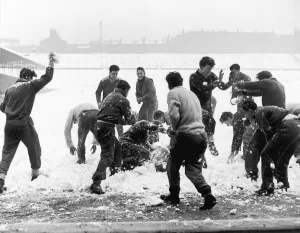 Birmingham City training. Players enjoying a snowball fight on the snow covered pitch