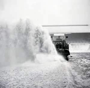 Groundsman Prints: Birmingham grounds staff seen here clearing snow from the pitch at St Andrews in January