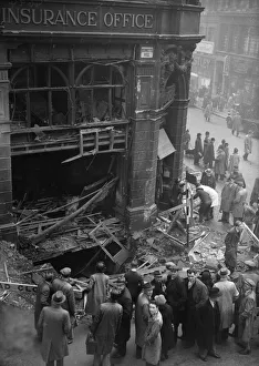 01466 Prints: Birmingham residents inspect a bomb crater at the corner of Bennetts Hill and New Street