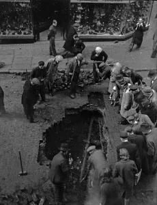 01466 Prints: Birmingham residents inspect a bomb crater in Corporation Street, Birmingham