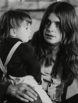 Black Sabbath lead singer Ozzy Osbourne holding his 22 month old daughter Jessica