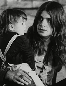 Rockers Prints: Black Sabbath lead singer Ozzy Osbourne holding his 22 month old daughter Jessica