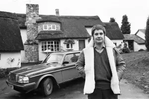 Black Sabbath singer Ozzy Osbourne pictured outside his new house, beside his Volvo car