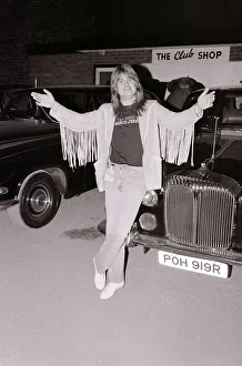 Black Sabbath singer Ozzy Osbourne poses next to a car after performing in concert August