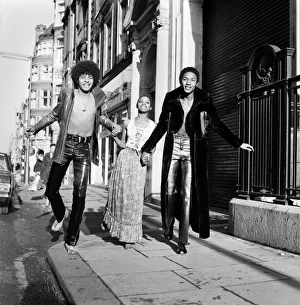 Black teenage boys and girls wearing fashion during a photo shoot