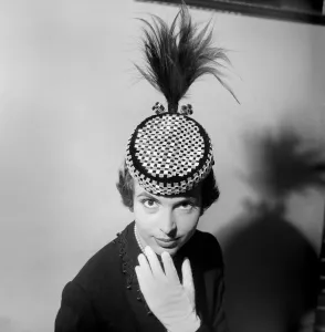 A black and white check board pill box hat with osprey trimmings worn by Marla Scarafia