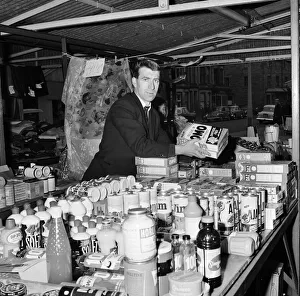 Blackburn Rovers footballer Bryan Douglas serving on his stall at the Morecambe market
