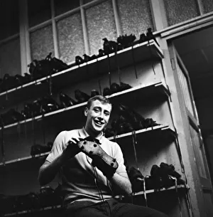 00431 Prints: Blackburn Rovers forward John Byrom cleaning his football boots. December 1964