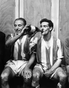 00254 Prints: Former Blackpool buddies Stanley Matthews and Jack Mudie relax in the dressing room