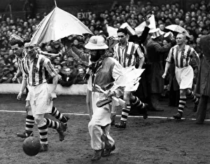 Blackpool v. Colchester. The Colchester team were escorted on to the field by their
