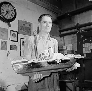 A blind model maker completes his latest model boat Circa 1957