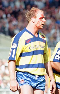 Bloodied Bob Jackson of Warrington is dejected after their defeat by Wigan in the Rugby
