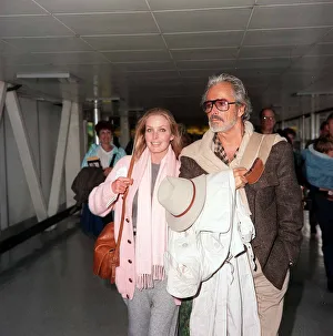 Square Prints: Bo Derek actress and husband film director John Derek at London airport. November 1986