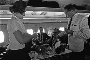 BOAC Steward and Stewardess serving drinks during a proving flight between Heathrow