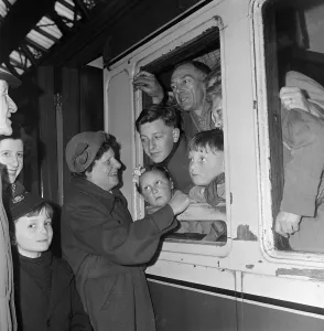 A boat train carries emigrants to Australia from St Pancras to the SS Arcadia