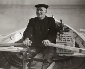 Boatman Old Alick rows the holly-topped Christmas boxes from the families ashore out to