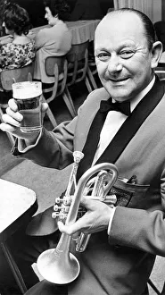 Bob Dunning a member of the Ashington Colliery Band raises his glass in a toast to his