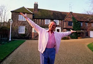 Bob Monkhouse outside house arms spread April 1989