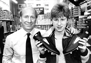 Bobby Charlton with budding soccer star paul Barrett when he chose a pair of football