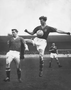 Brothers Prints: Bobby Charlton (left for Manchester United) in an action clash with his brother Jack