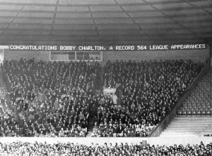 Electronic Prints: Bobby Charlton has his name in lights on the new electronic scoreboard at Old Trafford