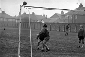 Bobby Graham, Evans and Ross who was acting as goalkeeper during a spot of training