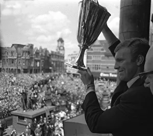 Bobby Moore holds aloft the European Cup Winners Cup trophy to the people of West Ham