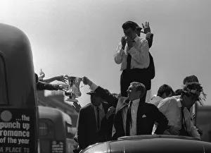 Bobby Moore holds up the FA Cup during the parade around East London after the Hammers