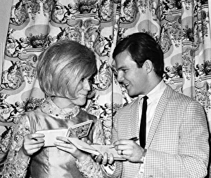 Bobby Vee and Dusty Springfield exchange autographs during the interval of their one