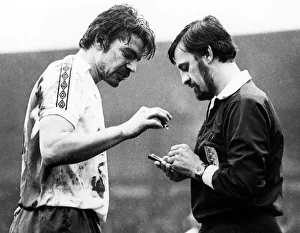 Bolton player Sam Allardyce is booked and gives the referee a piece of metal from