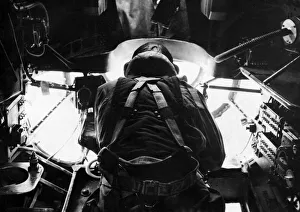 A bomb aimer in position in the nose of an RAF Stirling bomber during an assault