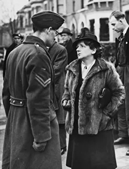 Bombed School. Miss Ellen Wilkinson sympathising with Corporal L. G
