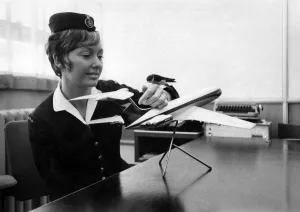 Bonzo the housemartin perched on the hand of an airline hostess for farewell pictures
