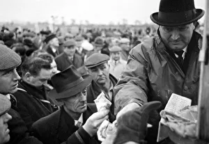 00170 Prints: Bookmaker taking bets from crowds of punters before the race at Leopardstown in Ireland
