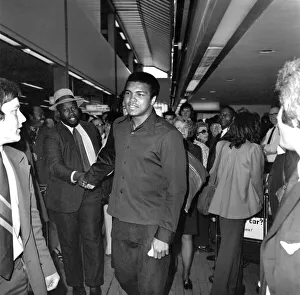 00326 Prints: Boxer Cassius Clay. Heavyweight boxer Cassius Clay arrived at Heathrow Airport on his way