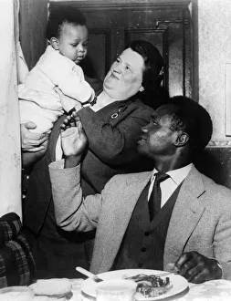 Dinner Prints: Boxer Hogan Bassey, pictured with Bessie Braddock at his home in Liverpool, Mrs