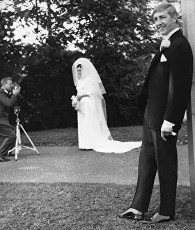 Suit Prints: Boxer Ken Buchanan poses for the press during his wedding whilst his wife Carol poses for