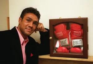 00130 Prints: Boxer Kevin Lveshing at home in Westerham standing in front of cased boxers gloves