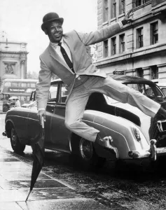 Suit Prints: Boxer Sugar Ray Robinson doing an impression of Sammy Davis Junior dressed in a city