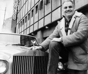 Boxing promoter Alex Morrison standing next to Rolls Royce outside the Barrowlands in