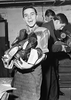00686 Collection: A boy carries a bundle of shoes. He is 'at work'