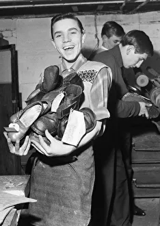 Cobbler Prints: A boy carries a bundle of shoes. He is at work
