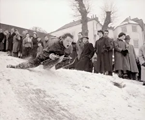 Sleighs Prints: A boy goes flying down a snow covered hill on a sledge at Hampstead Heath February