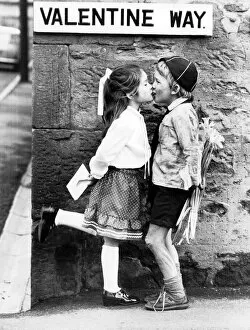 Images Dated 13th February 1982: Boy holding flowers behind his back kisses on Valentines Day