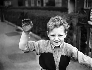 00702 Prints: A boy plays on his tricycle on a council estate as his mother looks on 1955