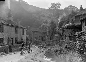 River Prints: Two boys out on their bicycles near a stream in the Peak District village of Castletown