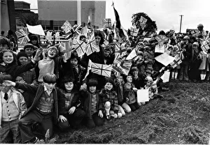 Boys and girls eagerly await the arrival of Queen Elizabeth II near Wrexham, Wales